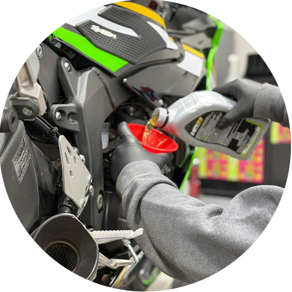a technician changing the oil on a UTV
